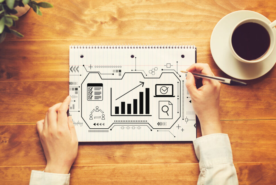 Marketing concept with a person writing in a notebook